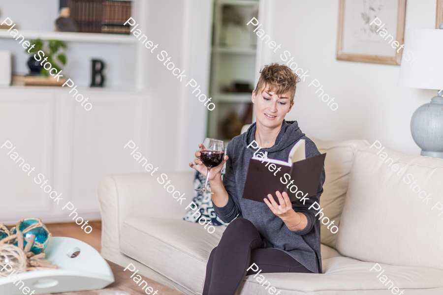 A young lady sitting on the couch stock photo with image ID: ec917a7a-7ce7-4cd7-b855-4845a446fa20