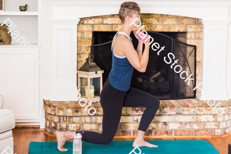 A young lady working out at home stock photo with image ID: 0074994e-2373-4c14-bab2-6230cf04c43d