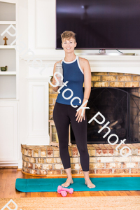 A young lady working out at home stock photo with image ID: 0b4861c3-7643-49f2-ad94-0393b7138a83