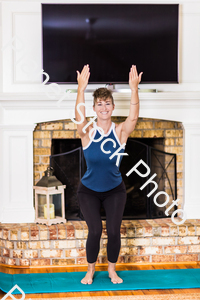 A young lady working out at home stock photo with image ID: 198824b4-c679-4b43-a923-8cd79e0baec4