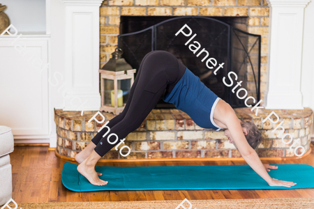 A young lady working out at home stock photo with image ID: 29cea4a7-e988-4ed2-a9bf-74d371861c0b