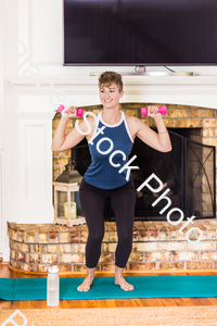 A young lady working out at home stock photo with image ID: 34d02840-0c8b-4fc7-b695-0eab833e8edc