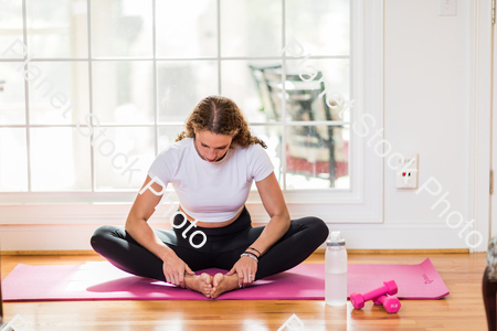 A young lady working out at home stock photo with image ID: 36665366-65a0-4903-b3f1-77a06147c0f5