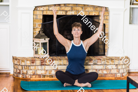 A young lady working out at home stock photo with image ID: 4132ec39-1477-4ad2-a99d-bd2bd2bce581