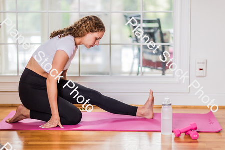 A young lady working out at home stock photo with image ID: 45783fdd-098d-4894-9295-555195069057