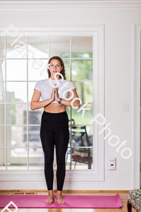 A young lady working out at home stock photo with image ID: 581c0ae7-492e-42e4-acf7-8163c1273152