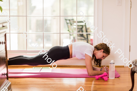 A young lady working out at home stock photo with image ID: 5c645a05-965e-46b8-964a-9c6046dea12c