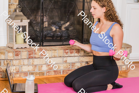 A young lady working out at home stock photo with image ID: 63cad894-1d7b-493e-8c5b-4b3c3969104a