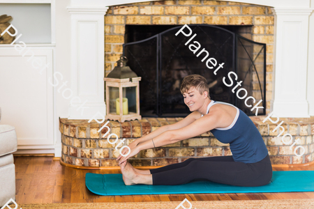 A young lady working out at home stock photo with image ID: 6c679aa5-4d7b-4dff-a546-8543523267b4