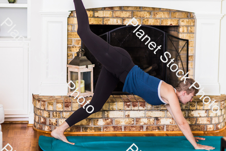 A young lady working out at home stock photo with image ID: 7b8f249f-78b1-4fa2-a941-d55f69ff736d