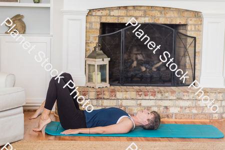 A young lady working out at home stock photo with image ID: 98237133-6d35-4bb0-aeea-f33b99225e68