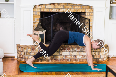 A young lady working out at home stock photo with image ID: a094122f-ef71-499b-93e7-513c88551d60