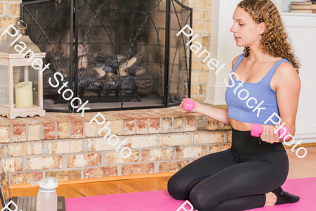 A young lady working out at home stock photo with image ID: bdd02c0b-de3c-42dd-98f2-f8c3614c6aca