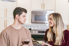 A young couple sitting and enjoying red wine